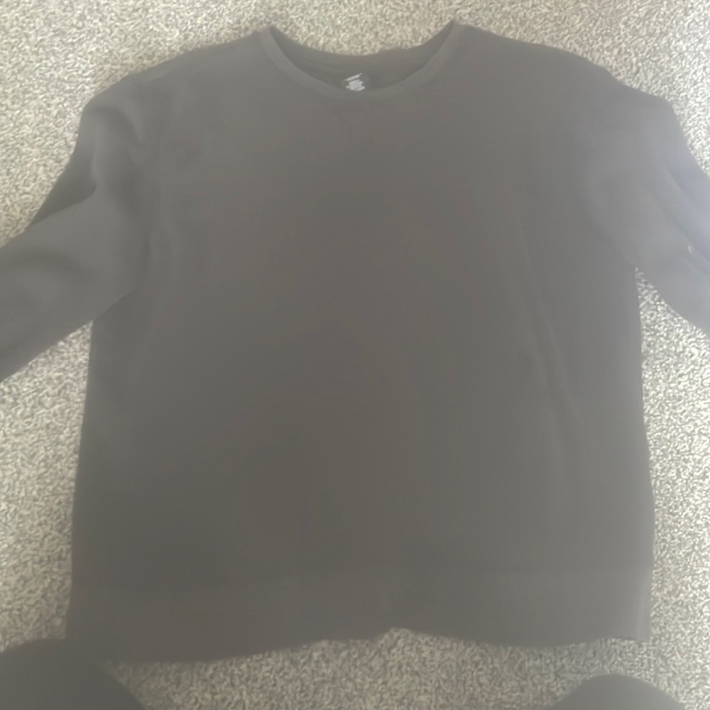 This is a plain black crew neck in a size small